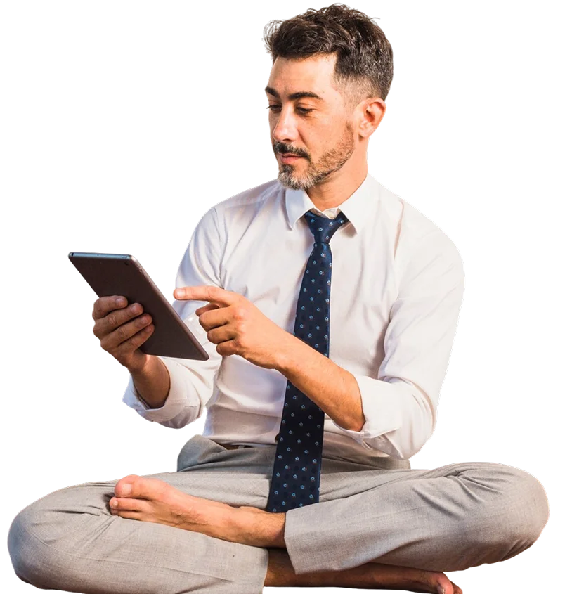 Professional man in white shirt and tie using tablet while sitting cross-legged, representing Web App Services digital workspace and technology solutions